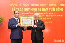 60-year Party membership badge presented to former Party chief Nong Duc Manh