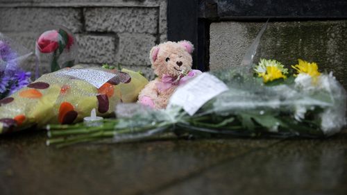 Funeral home where police removed 35 bodies and 'human ashes' has flowers placed at scene