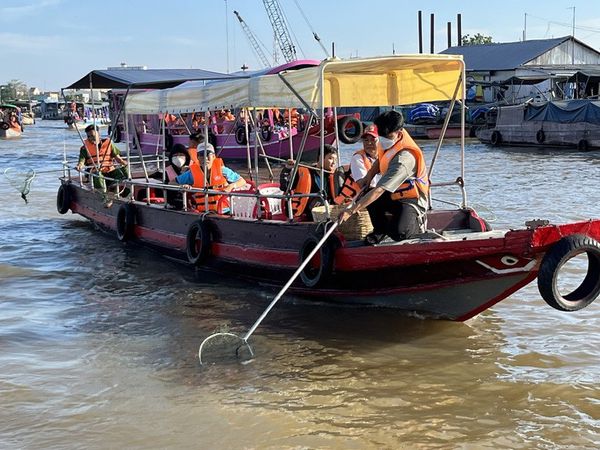 Young people collect garbage from iconic Cai Rang Floating Market in southern Vietnam