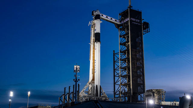 Crew awaits weather-delayed launch to space station