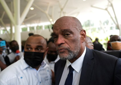 Haiti’s prime minister is locked out of his country and faces pressure to resign