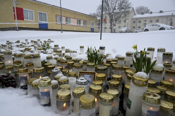 Mourners gather outside a Finnish school where a shooter killed a 12-year-old and wounded 2 others