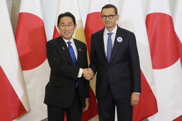 Japan’s leader holds security, business talks in Poland on his way to NATO summit