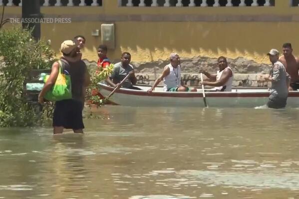 Neighborhoods in Brazil’s Rio de Janeiro state are flooded after rains that killed 12 people