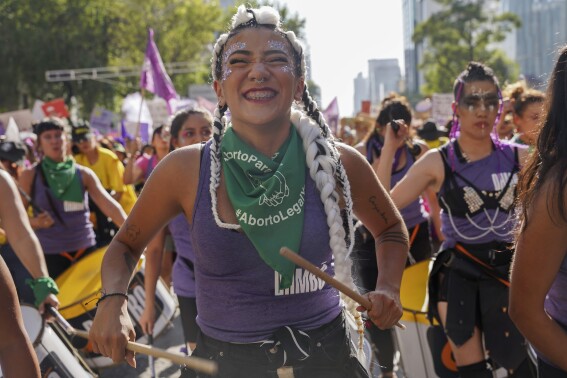 Facing historic shifts, Latin American women bathe streets in purple on International Women’s Day