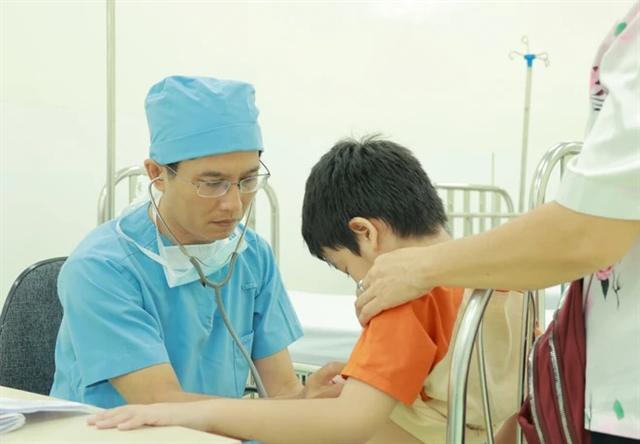 Doctor with golden hands heals young hearts