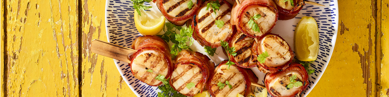 2022 May June CC_Bacon Wrapped Grilled Scallops_HR 1600x400.jpg