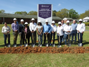 Line of people with shovels at the 2025 Community Center Ground Breaking.