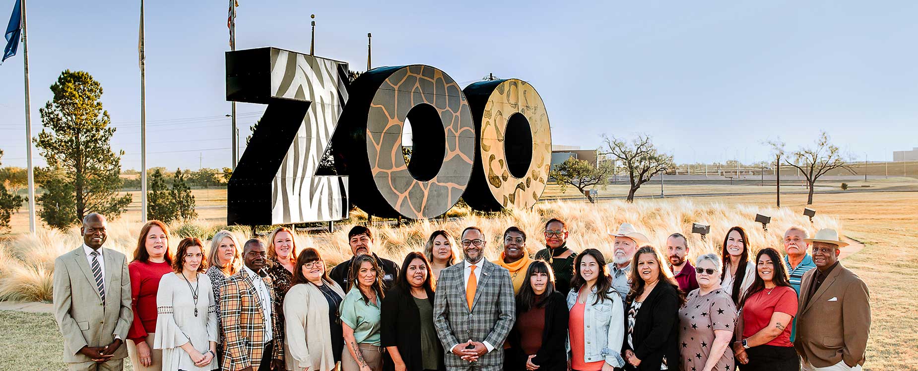 Abilene Housing AUthority Staff standing in front of Zoo sign