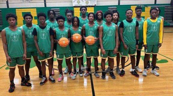 A group of boys standing next to each other and holding basketballs.