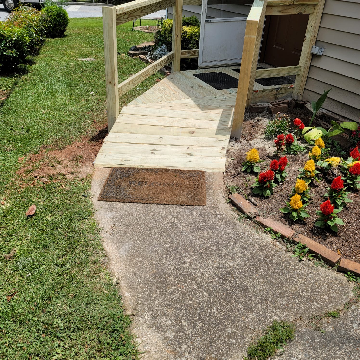Front door and landscaping after new ramp added.
