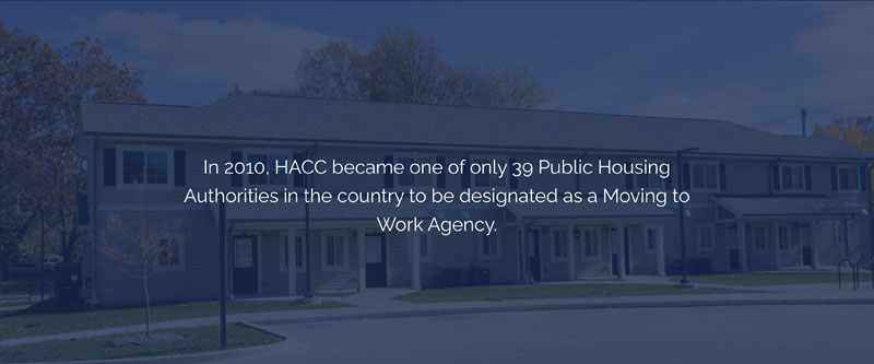 A housing complex with text that reads: In 2010, HACC became one of only 39 Public Housing Authorities in the country to be designated as a Moving to Work Agency.