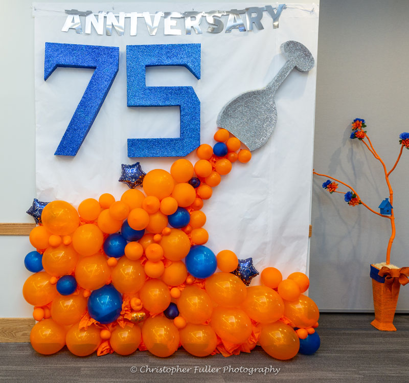 75th Anniversary Decorations with blue and orange balloons.