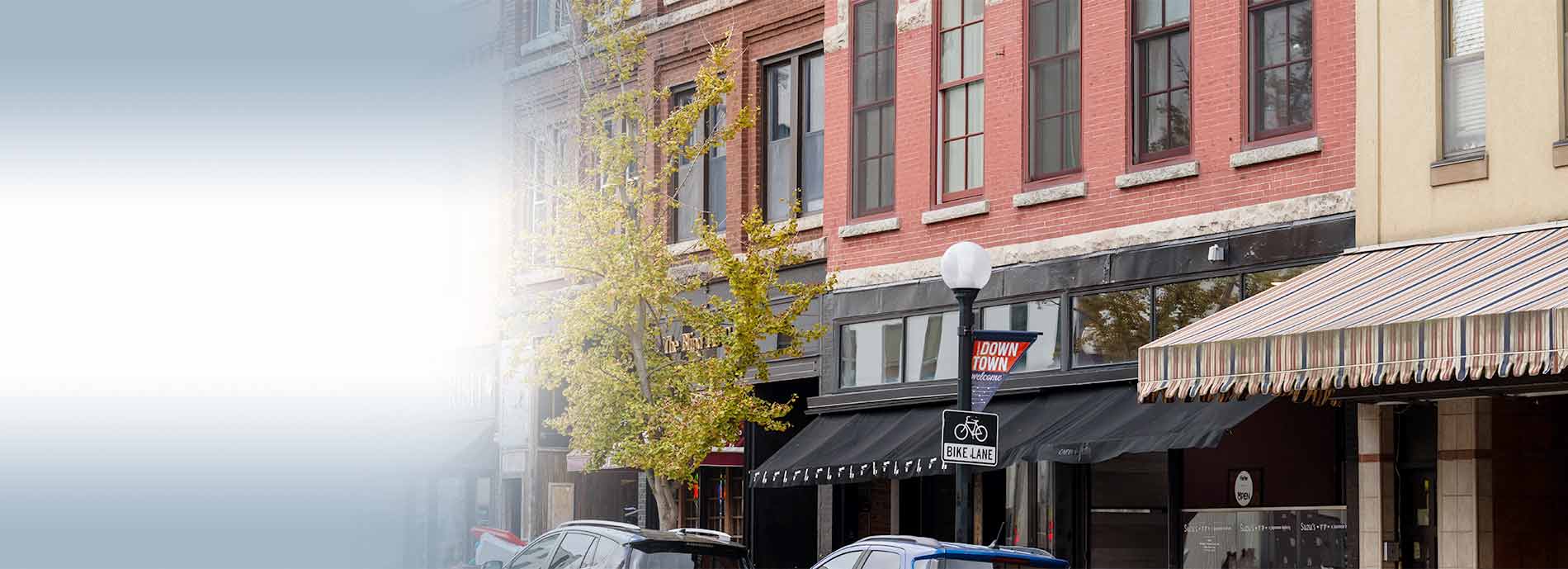 Street view of downtown shops, brick buildings