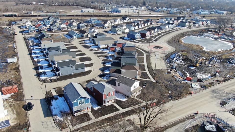 Aerial view of a planned community homes subdivision with a lake