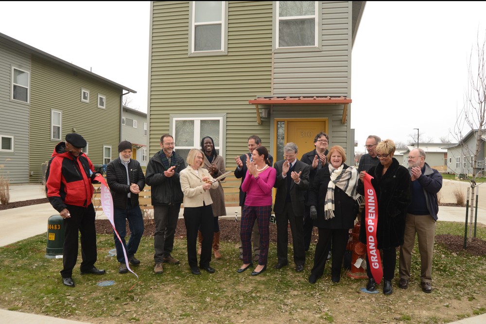A group of individuals at a ribbon cutting ceremony.