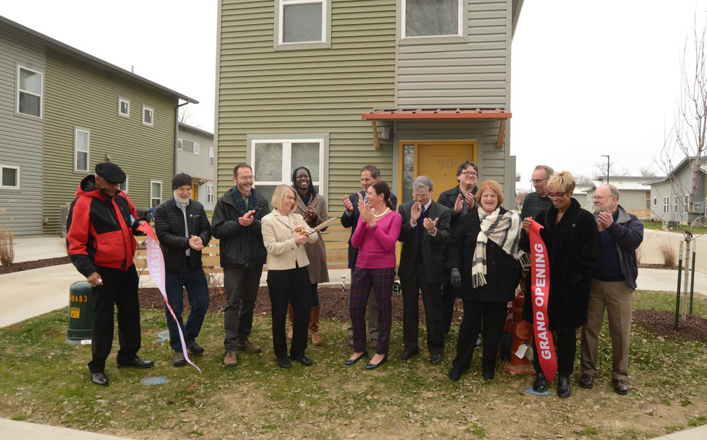 A group of individuals standing together at a ribbon cutting ceremony.