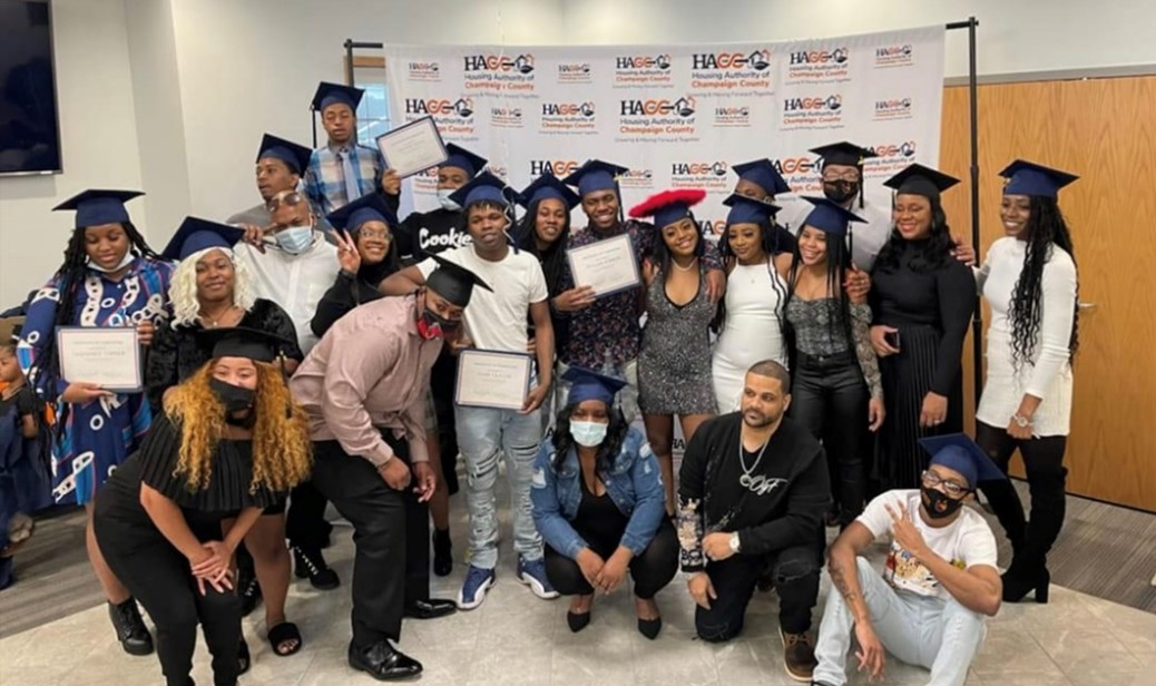 A group of YouthBuild graduates gathering for a photo.