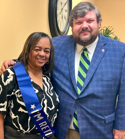 A man standing with Murenda when she Retired from CHRC.
