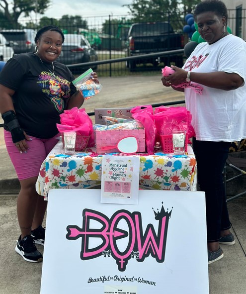 Ladies standing by a table for BOW at the 2024 Family Fun Day Back-to-School Bash.