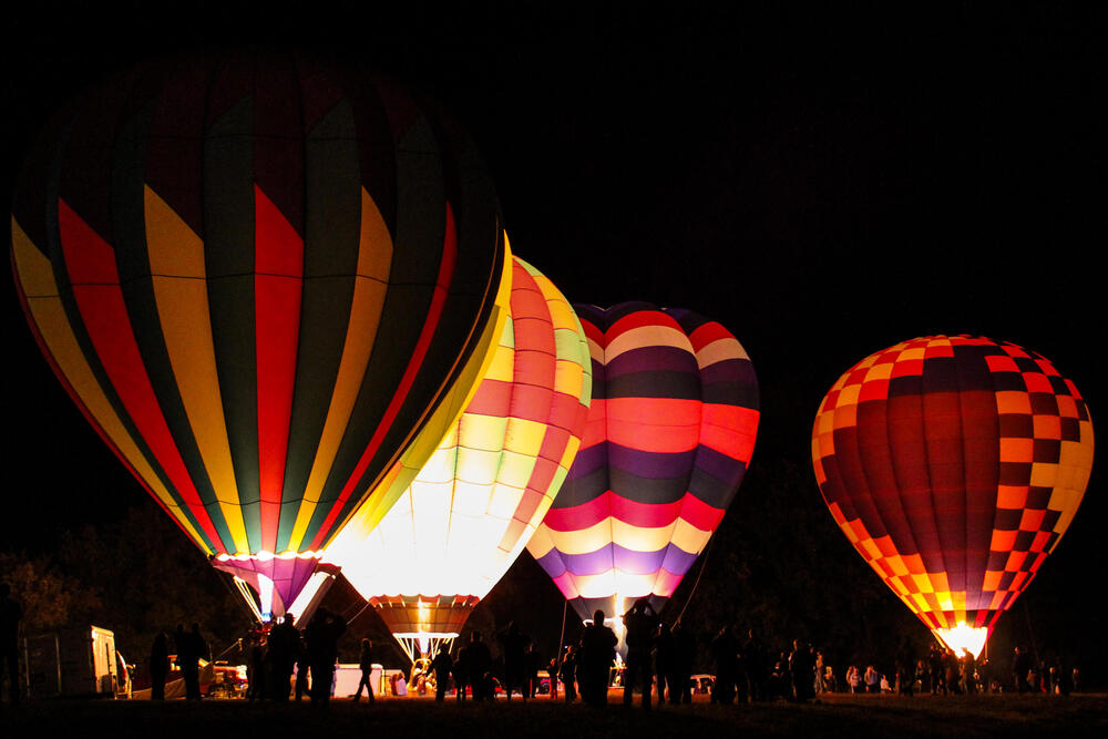 A close up of hot air balloons at night.