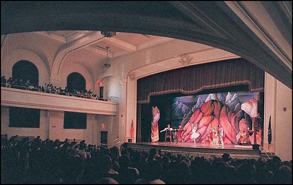 A play production at the Parsons Municipal Auditorium with a full crowd.