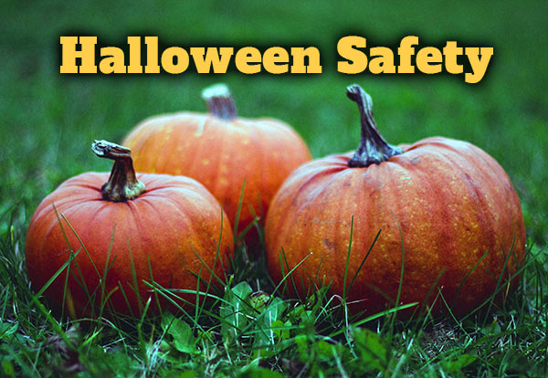 Halloween Safety. Three pumpkins sitting on the ground.