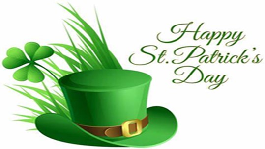 A hat in front of a clover and some grass. Happy Saint Patrick's Day.