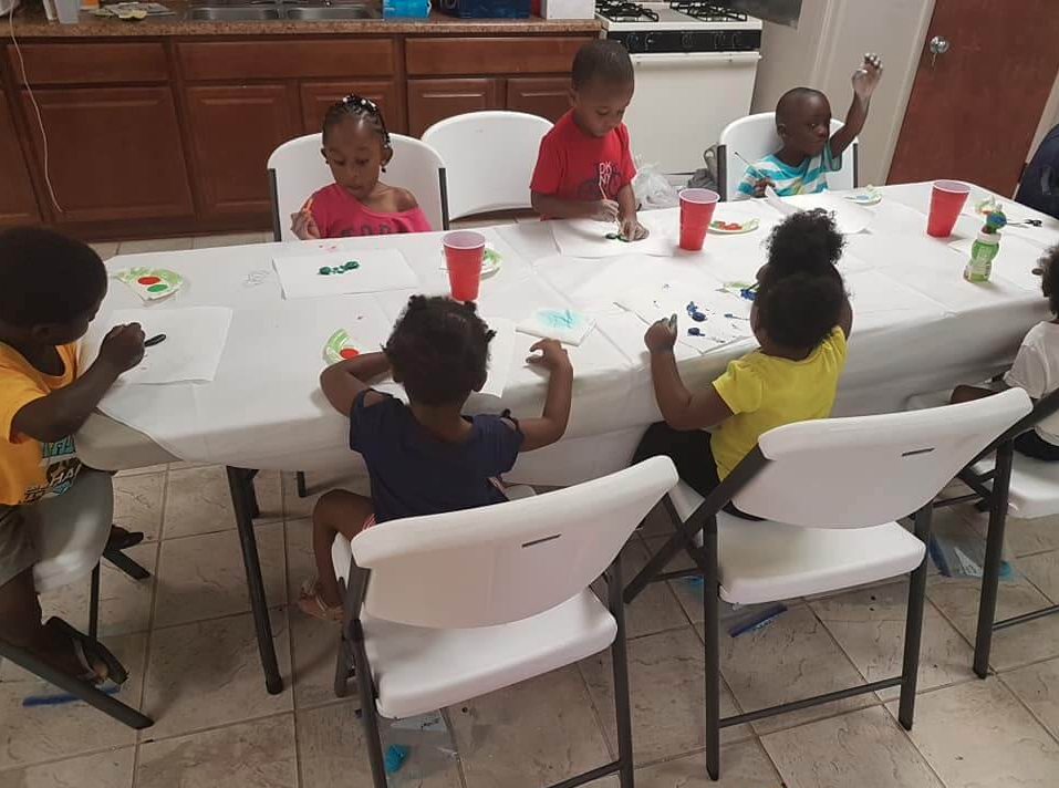 Children playing with slime and rocks.