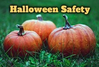 Three pumpkins in the grass with text that reads Halloween Safety.