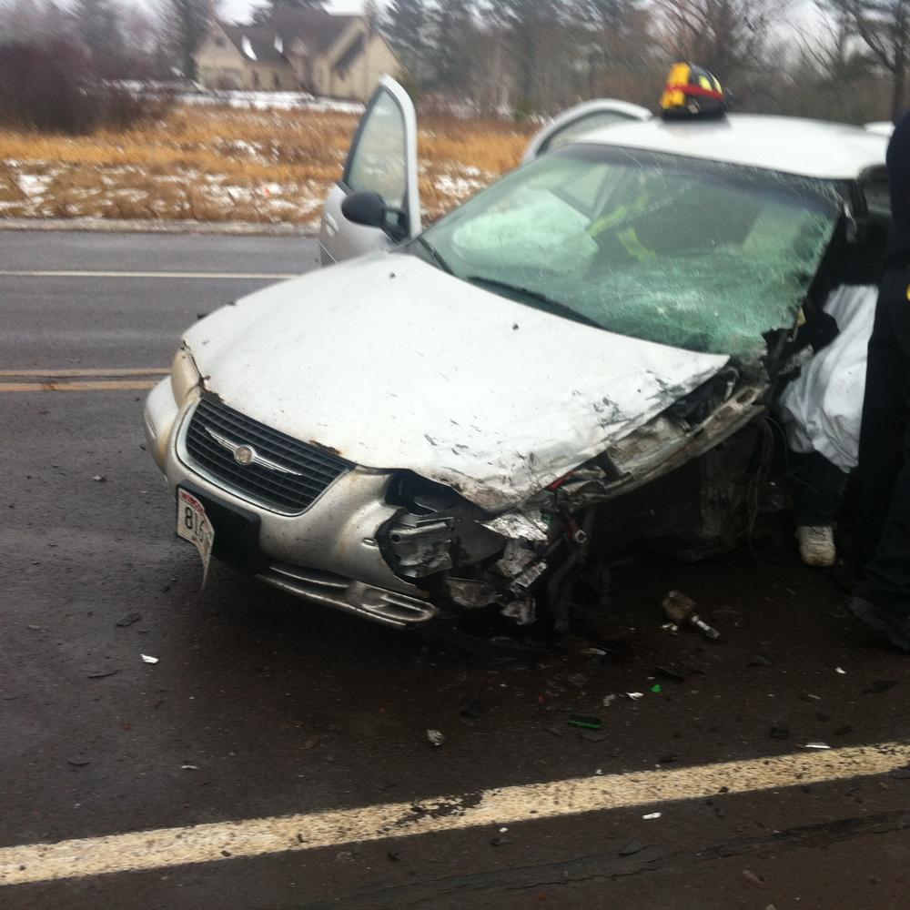 vehicle with scraped side and smashed windshield, with doors open