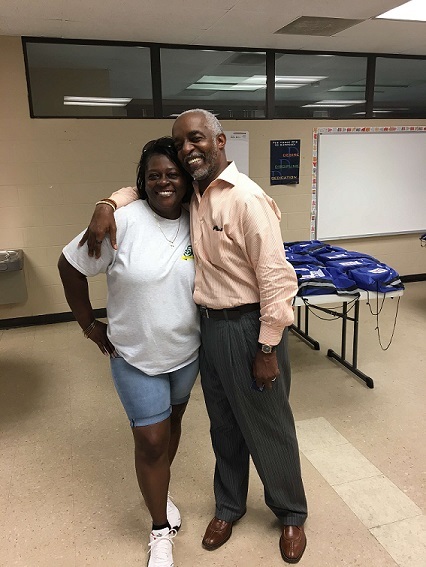 A man giving a woman a side hug.