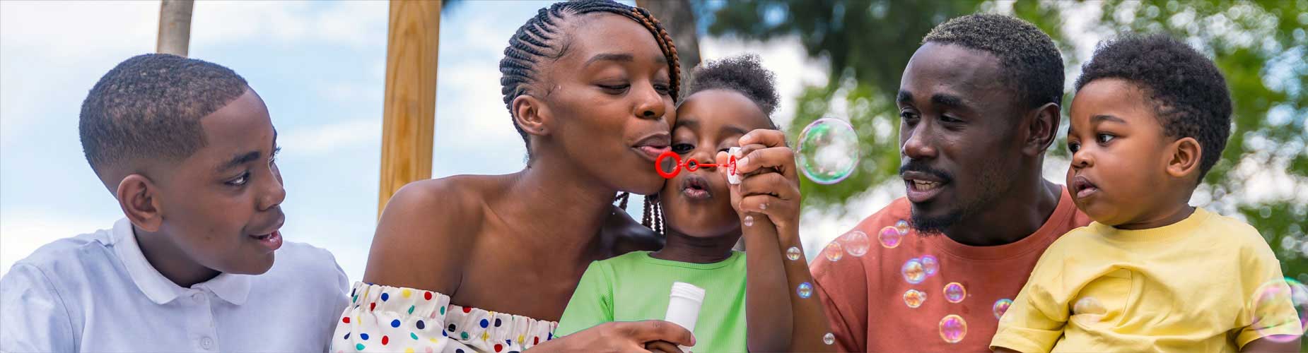 Parents and three children blowing bubbles