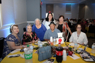 A group of women and a man at a table.