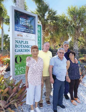 Group in front of a sign board. 