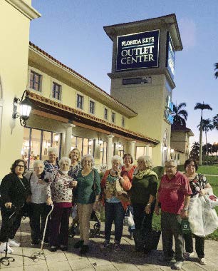 Group posing in front of an Outlet Center.