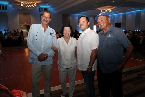 Four people standing in a row.