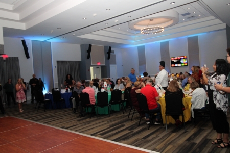 Groups of people at and around tables.