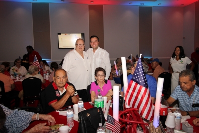 Groups of people at the Fourth of July party.