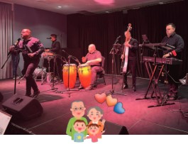 A group of men playing music on a stage.