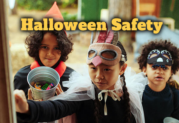 Halloween Safety. Three children dressed up in costumes knock on a door.