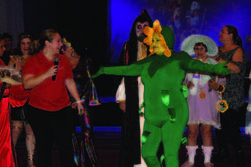 Individuals dressed in costumes at a Halloween party.