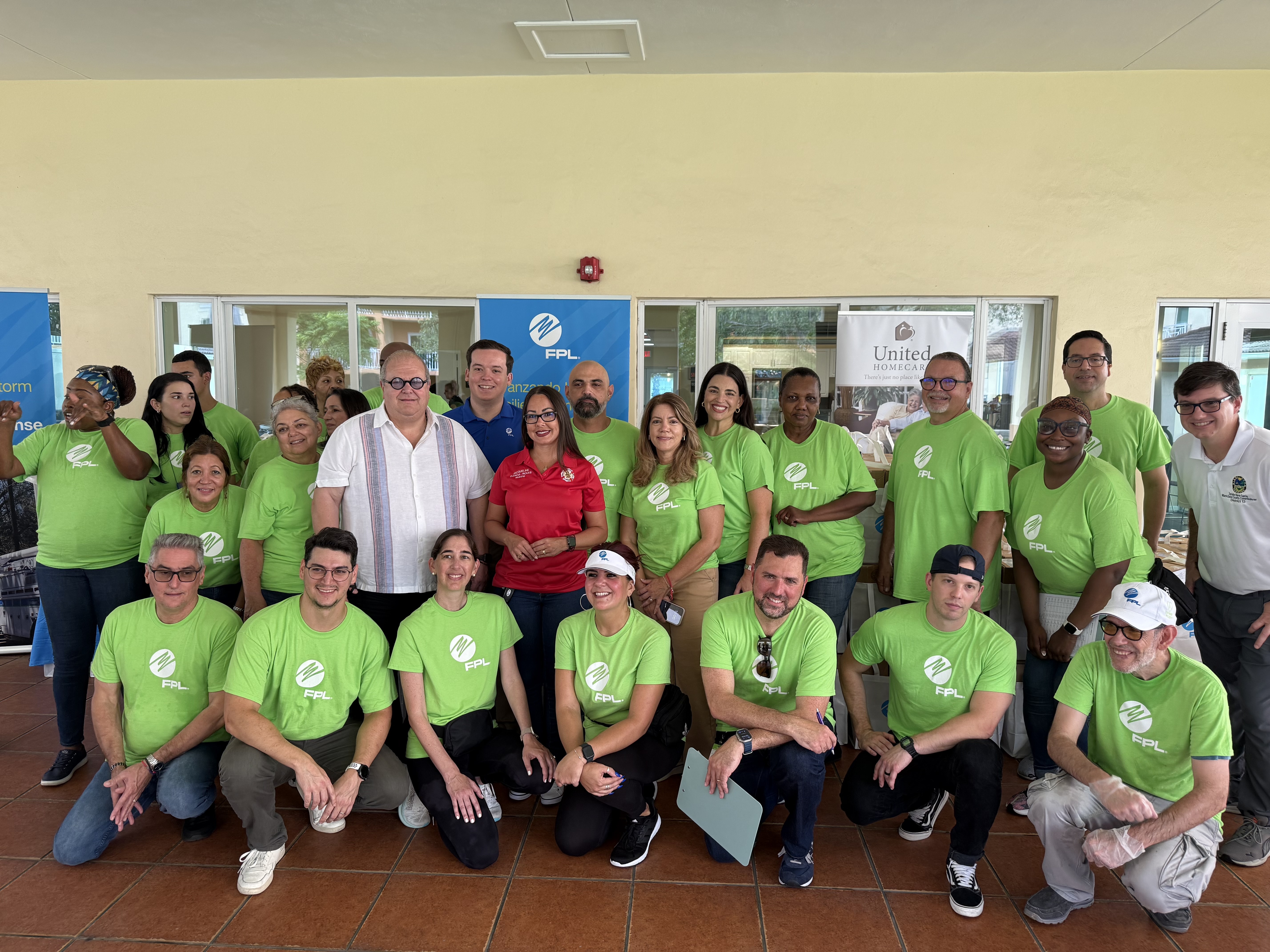 A large group of people smile at the Hurricane Preparedness Drive.