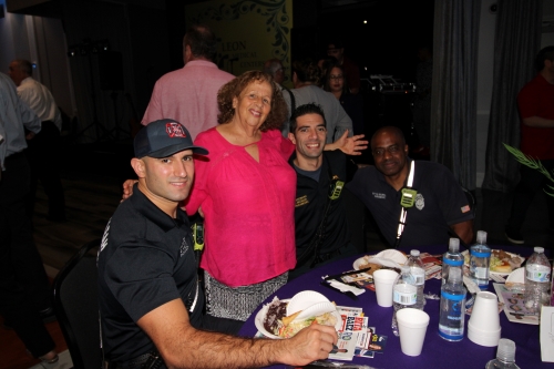 Lady standing with paramedics.