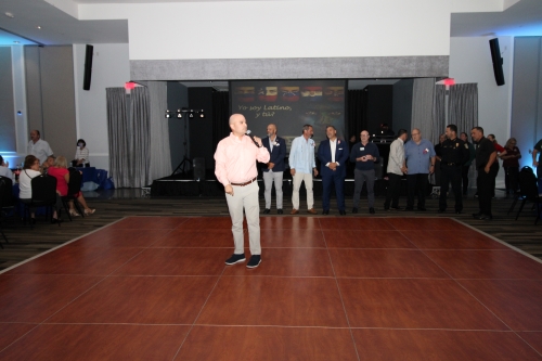 Man speaking in the middle of the dance floor.