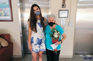 Miss Hialeah USA visiting a resident of Vivian Villas on Mother's Day.