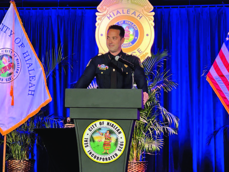 An officer speaking at a podium.