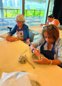 Two women making crafts.