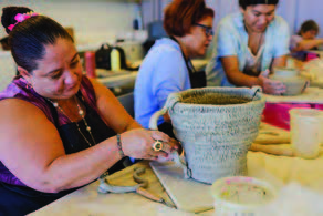 A woman crafting a large bowl.