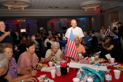 People visiting and having lunch at the Fourth of July Party.
